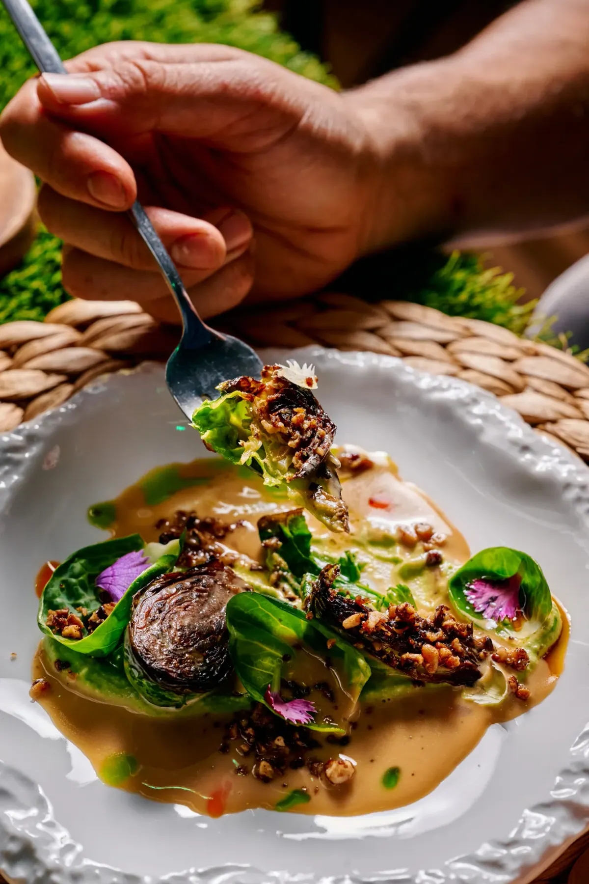 A course on the grass table, a fork lifting the first bite