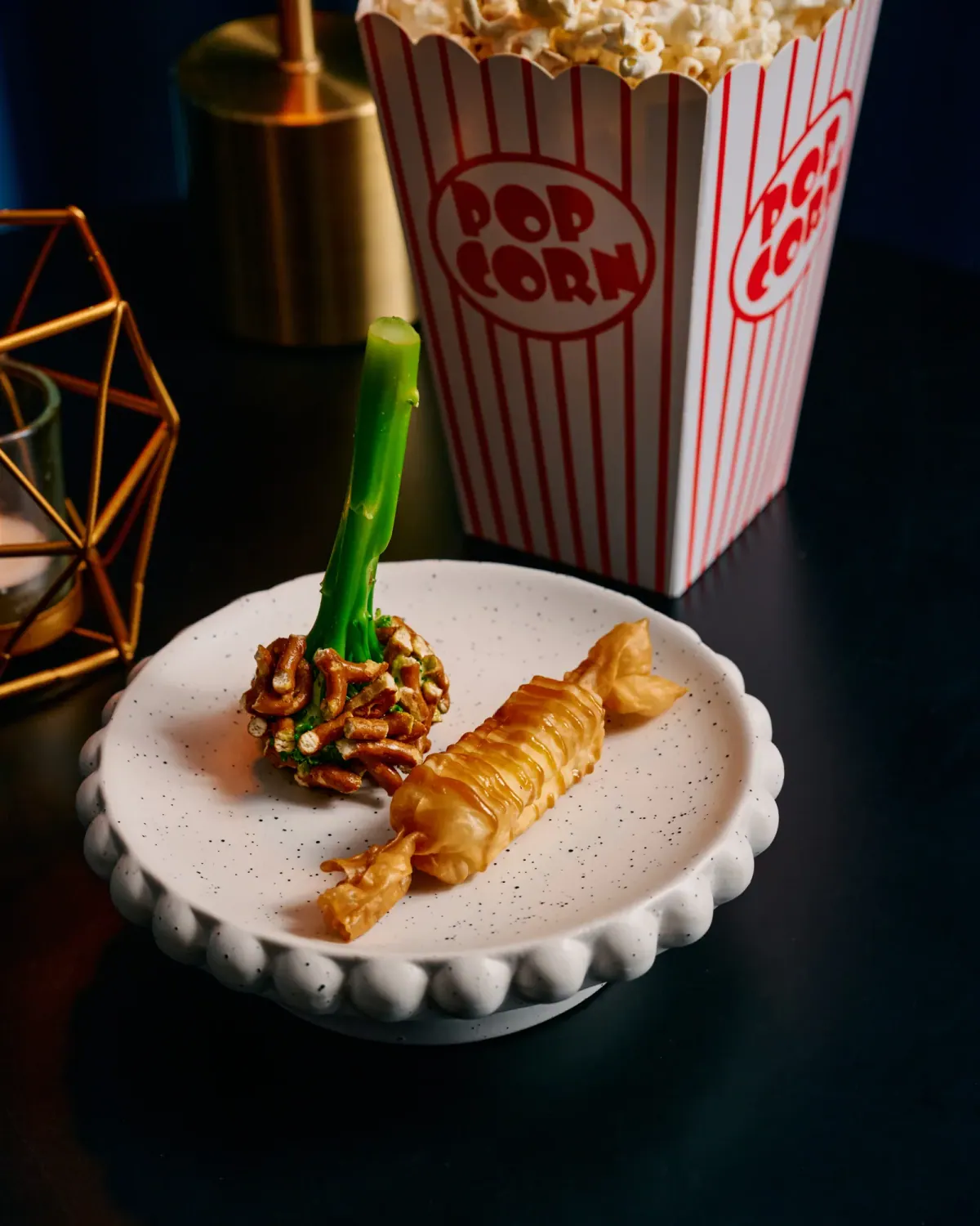 Crumbed prawn beside a box of popcorn, the cinema course