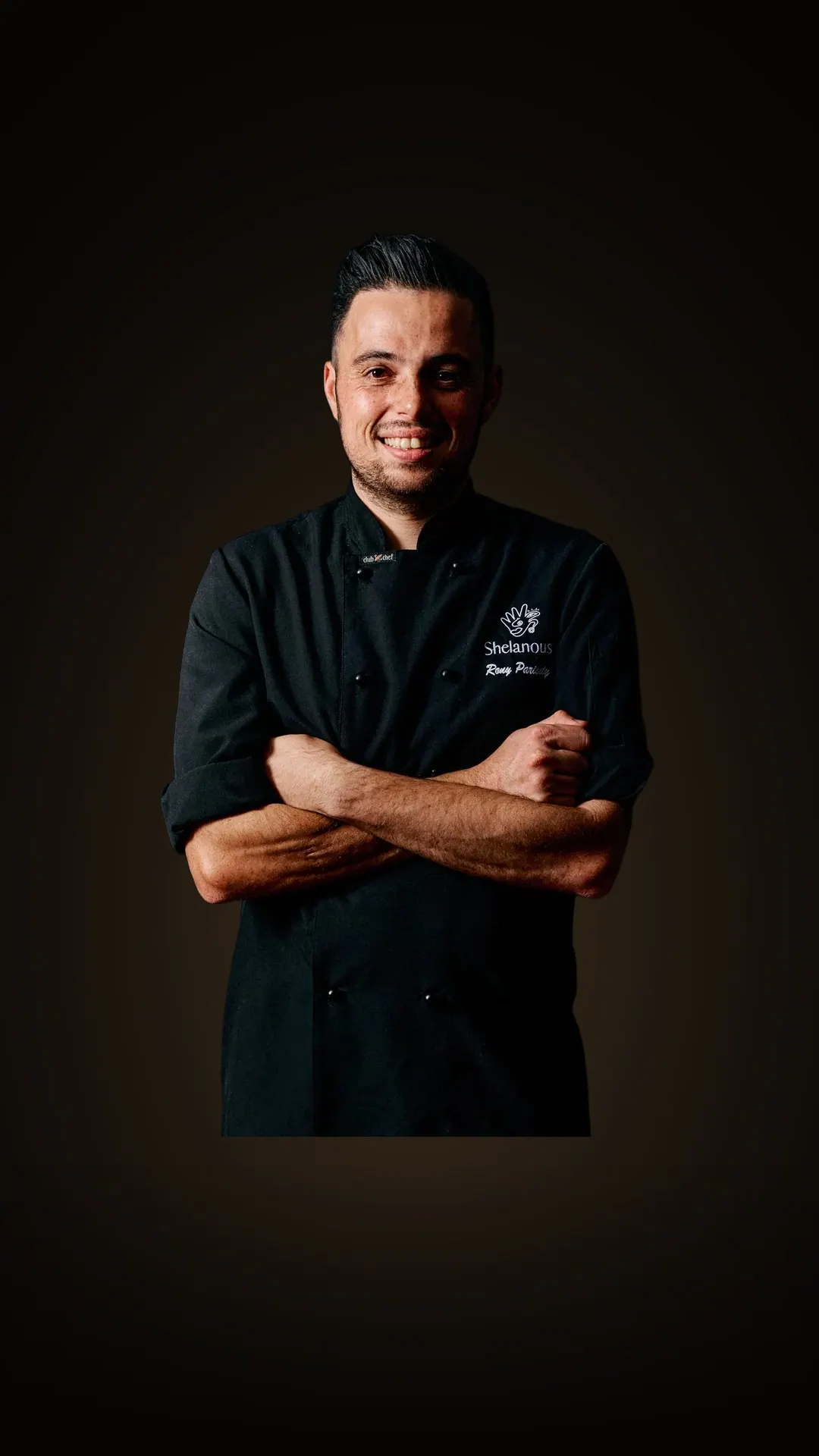 Chef Rony Parienty, arms crossed, in his black chef jacket